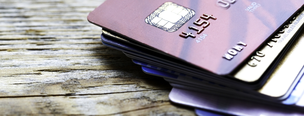 A close up photograph of a stack of credit cards.