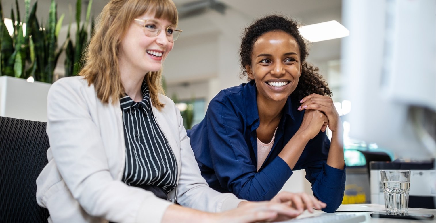Two women smile as they decide to claim their R&D tax credit.