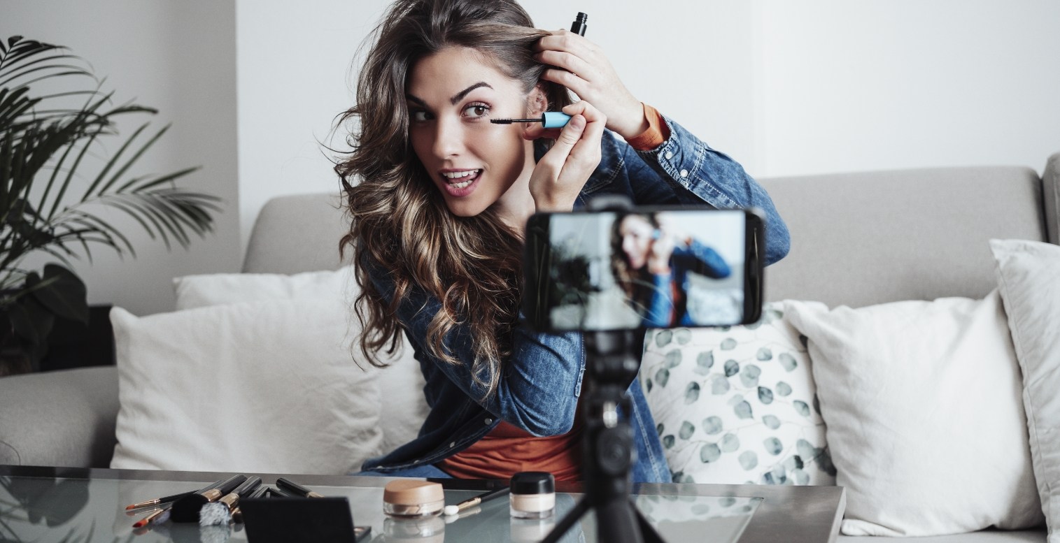 Woman uses smartphone to livestream her makeup routine for social media