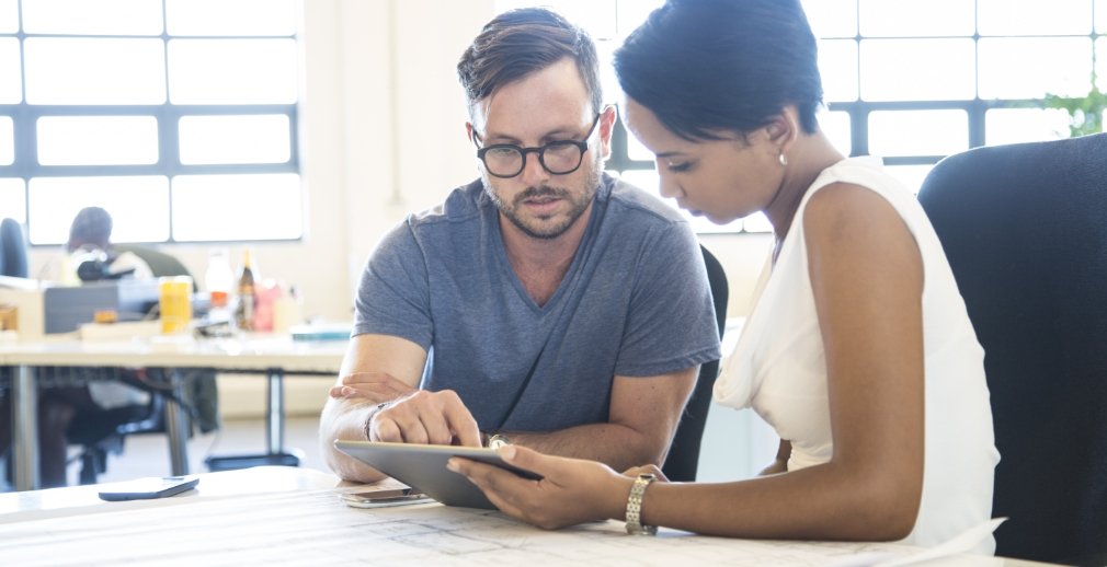 Staff members review data in their recruiting software