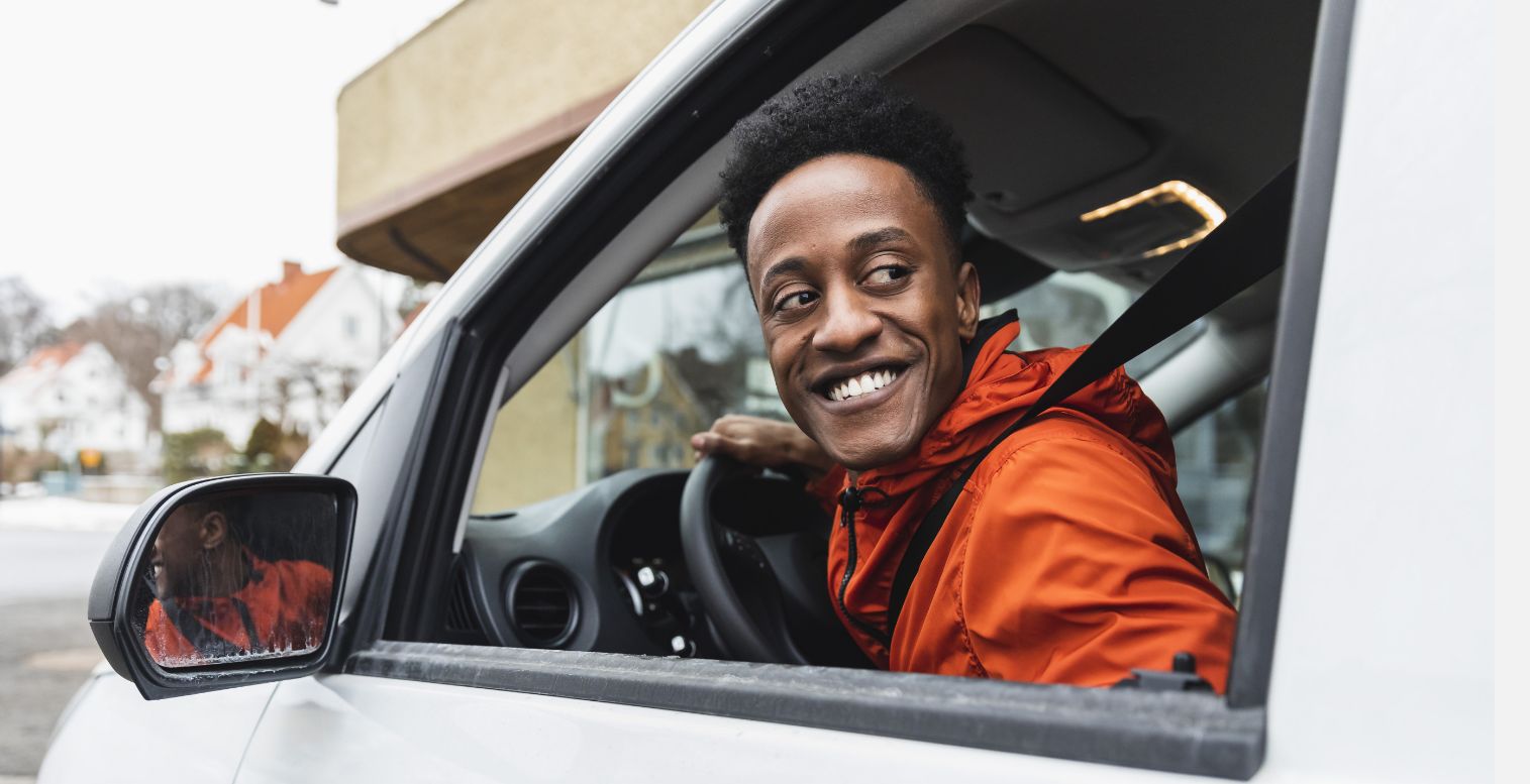 Male gig worker looking out the window of a white van