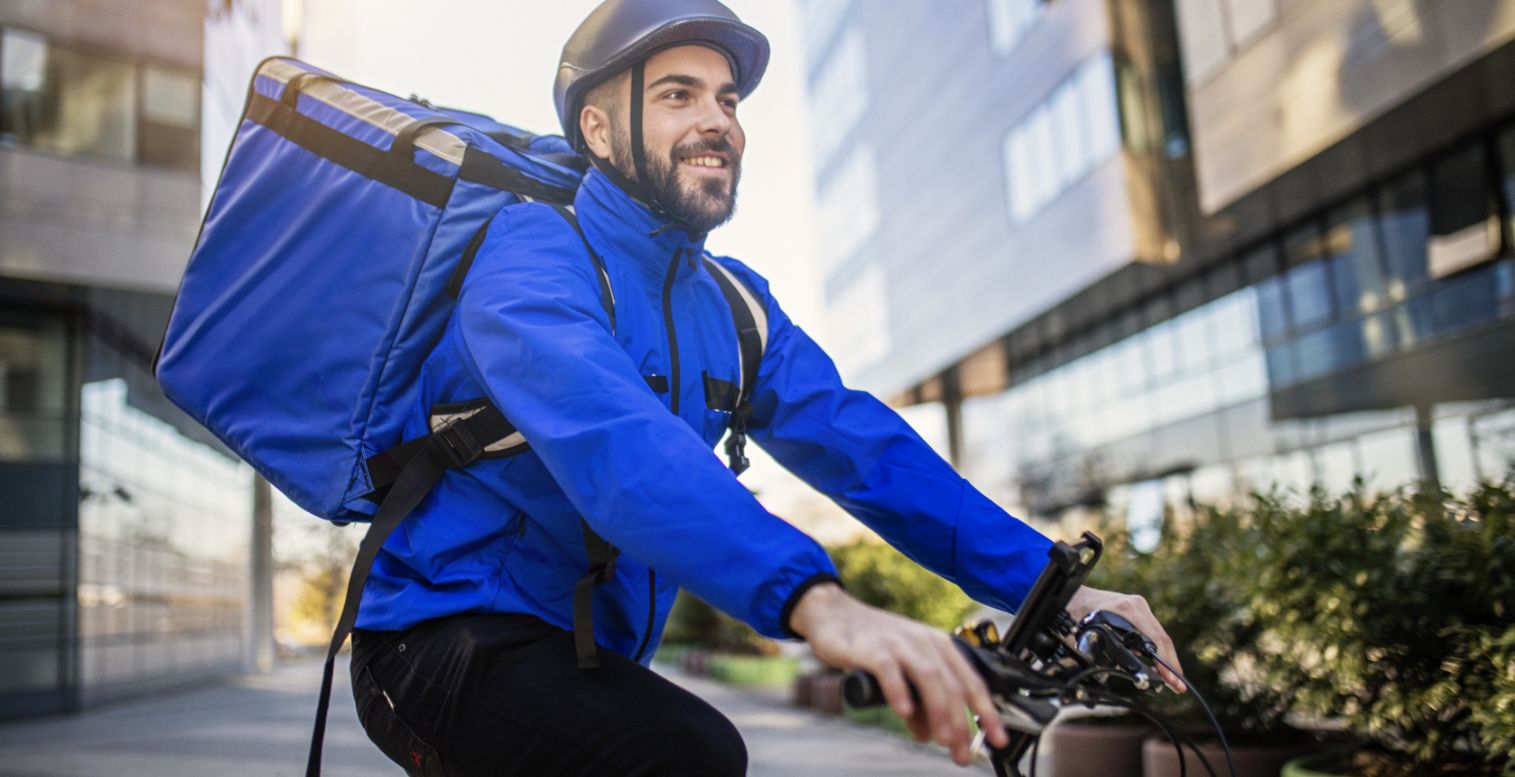 Food delivery worker on a bike with ain insulated backpack
