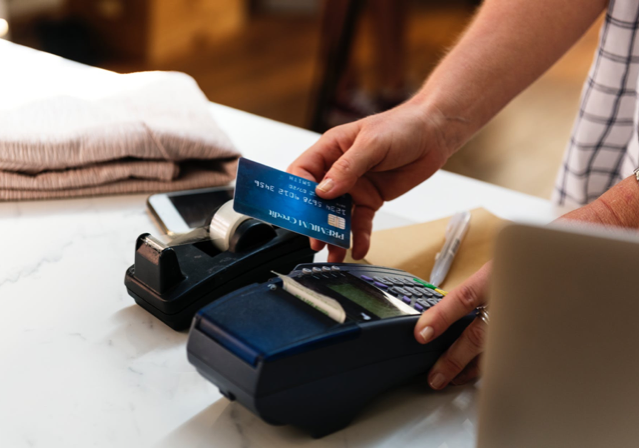 person making a payment with a credit card at a retail location