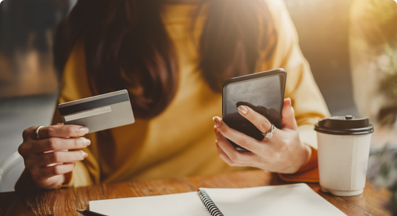 woman making a mobile payment at coffee shop