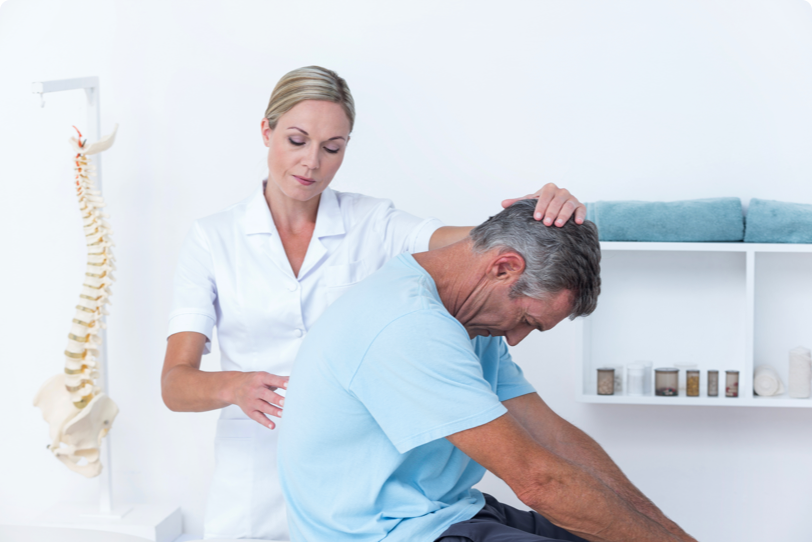 chiropractor adjusting a patient spine