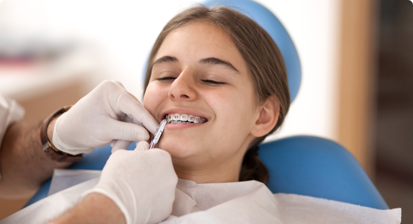 orthodontist working on girls braces