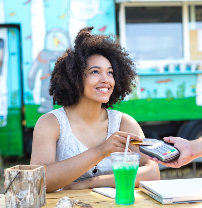 women paying with a credit card at her table at a restaurant