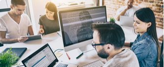 five people working around their computers together