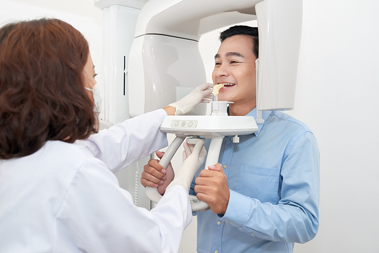 man getting x ray images taken at the dentist office