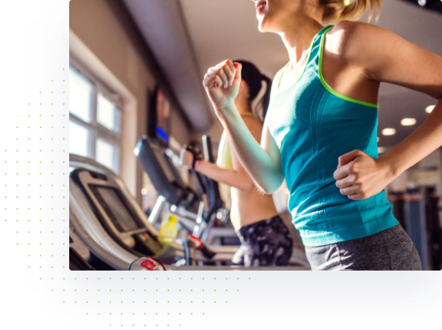 two women running on treadmills 